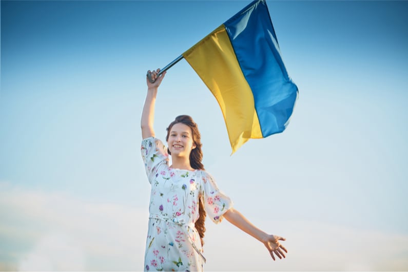 Young girl waving Ukraine flag