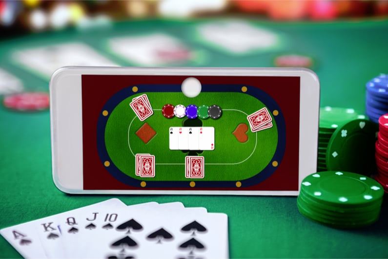 Smartphone with online poker table superimposed