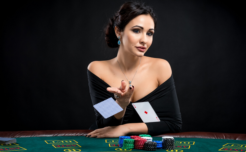 sexy woman throwing two cards at a poker table