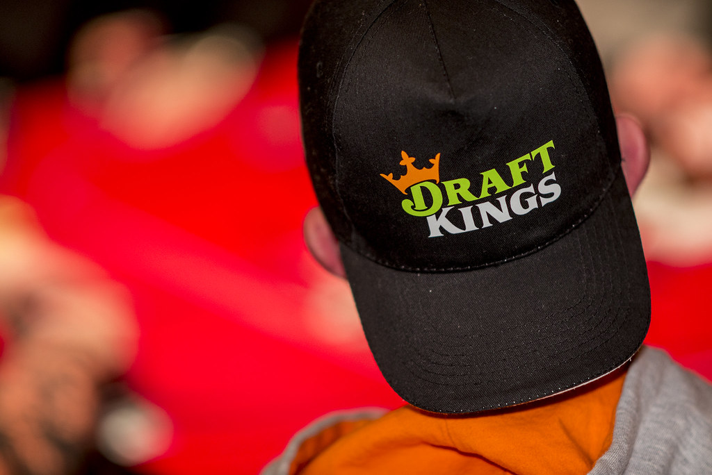 man wearing DraftKings branded cap