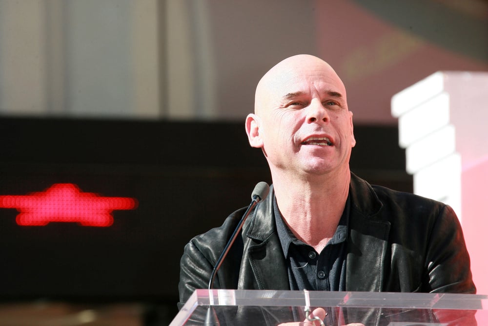 poker player Guy Laliberte speaking on a podium