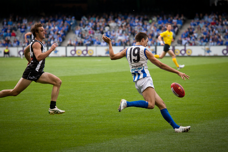 North Melbourne's Sam Wright kicks during their loss to Collingwood in April 2011