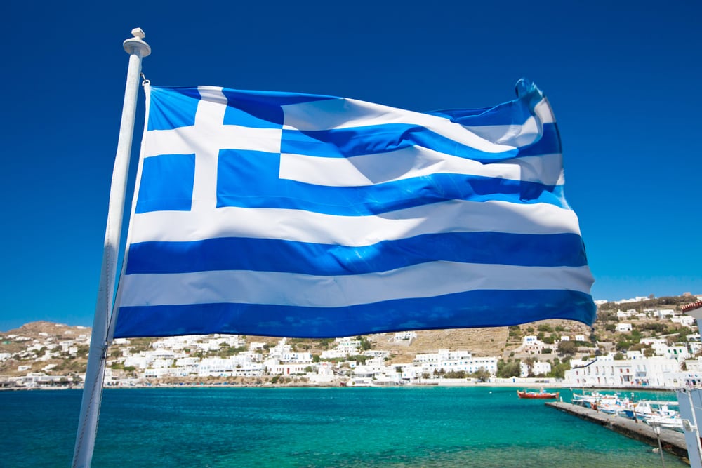 flag of Greece against Mediterranean island background