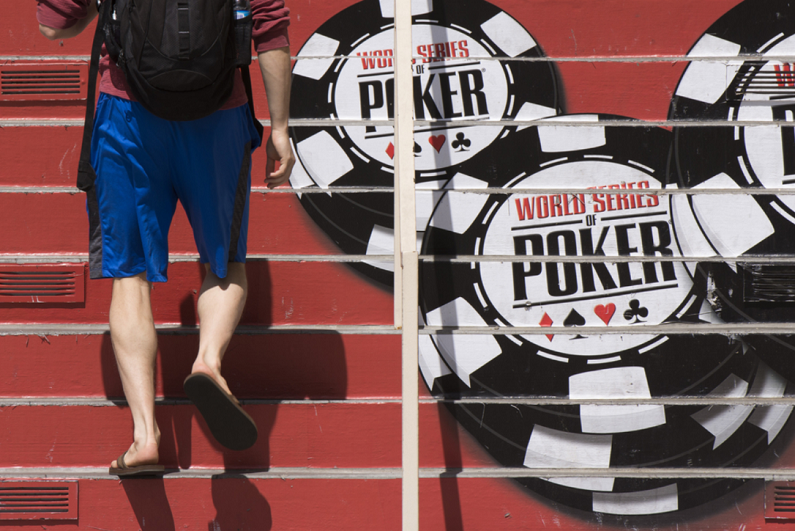 man walking up the steps at the entrance of the World Series of Poker