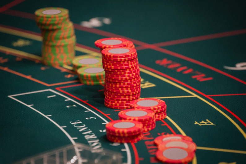 red and green chips on a baccarat table