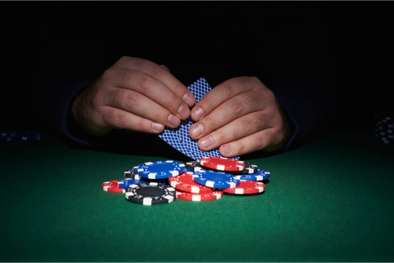 Poker player looking at hole cards