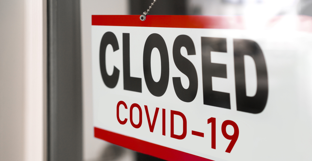 Closed store sign attributing closure to COVID-19