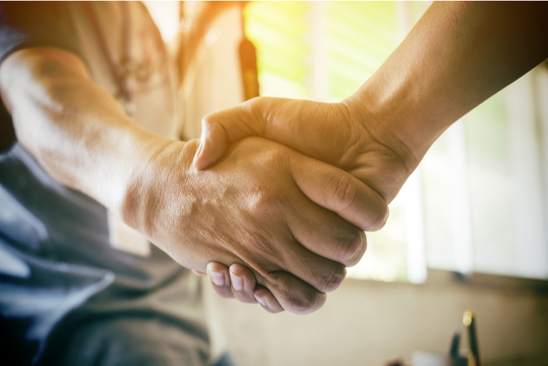 Handshake backlit with sunlight