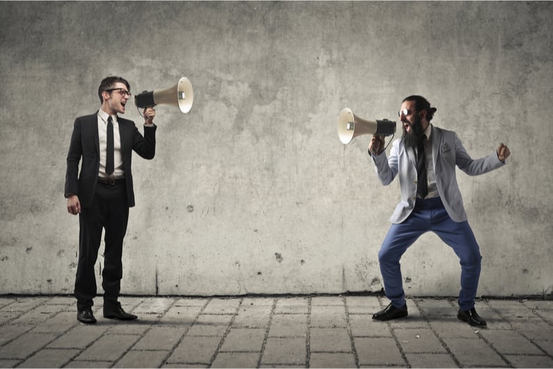 Two men yelling at each other with megaphones