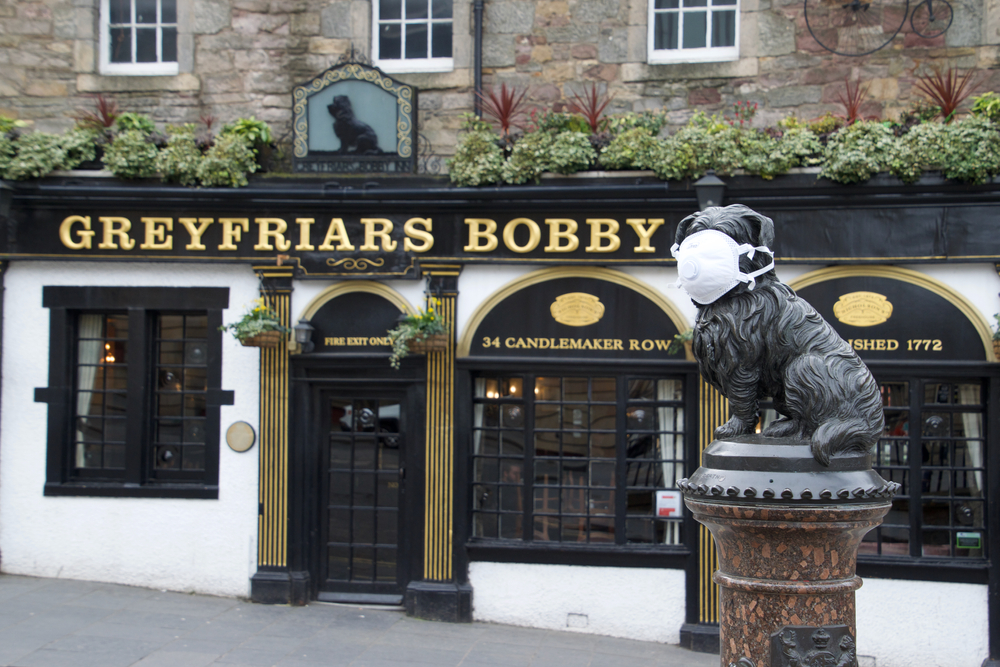 Greyfriars Bobby statue in Edinburgh protected with face mask during the COVID-19 pandemic